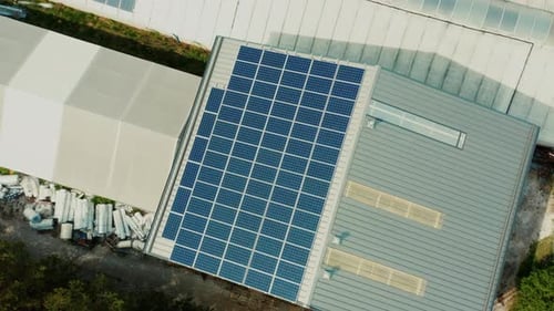 Aerial View Roof of Building with Photovoltaic Solar Panels on the Roof