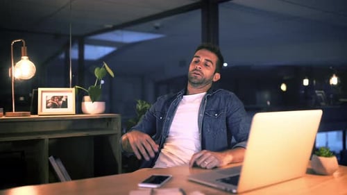 Man, tired and relaxing with legs on desk in office, late and work with exhaustion
