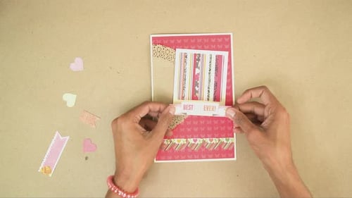 Hands Crafting a Colorful Handmade Greeting Card