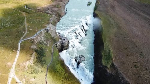 Majestic Aerial View of Gullfoss Waterfall in Iceland's Rugged Terrain