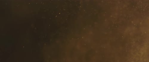 Schwebendes goldenes Staubpartikel