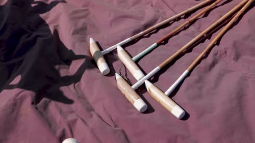 Polo Mallets and Ball Lying on Tarp