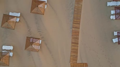 Top View Resort Beach at Summer Day Aerial Shot Wicker Umbrellas Lounge Chairs