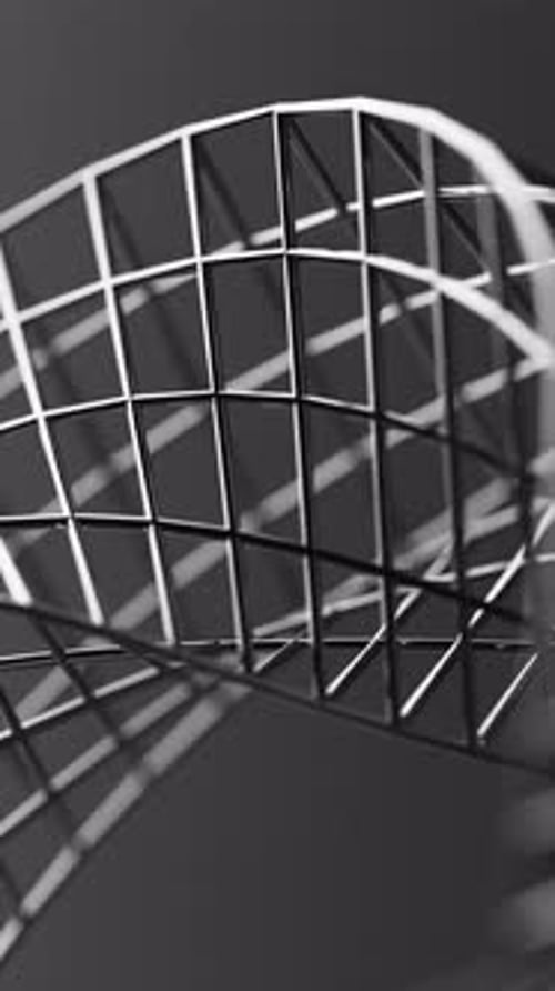 Futuristic 3D loop of a spinning Mobius form built from reflective chrome mesh.