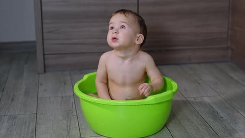 Baby Sitting in a Green Wash Basin