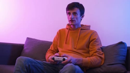 Young Man Playing Video Game on Couch