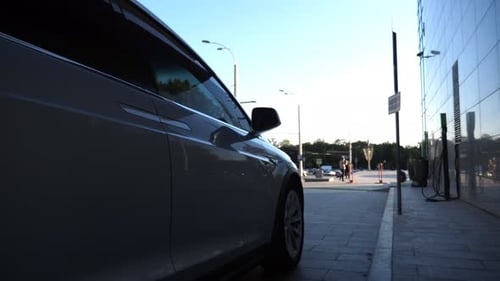 Modern Electrical Car Driving Up to Office Building Contemporary Electric Automobile Arrived to