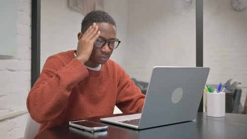 Adult Working at Laptop with Headache