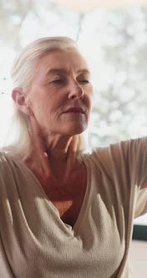 Senior Woman Meditating Indoors for Health and Wellness