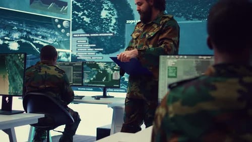 People in Camo Work in Tech-Filled Office