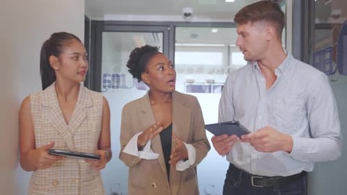 Multi-ethnic business staffs walk and discuss in the walk way of office about their project