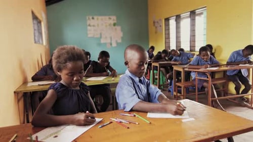 Malawi african school pupils draw with crayons in art class