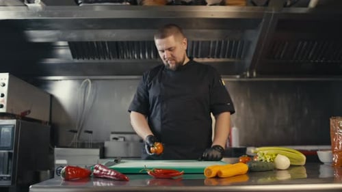 A Professional Chef Works in the Kitchen of a Restaurant
