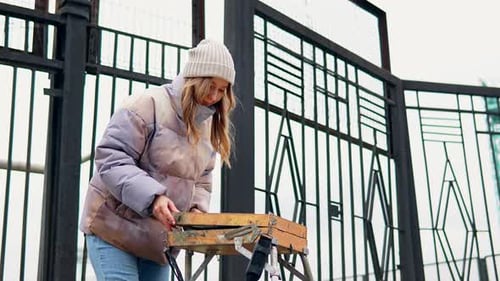 Slow Motion of Lady in Warm Clothes Preparing Art Stuff and Equipment to Paint Outdoors