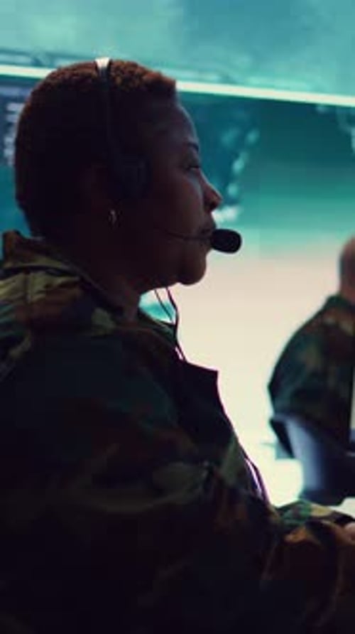 Woman in Camouflage Works at Computer Terminal
