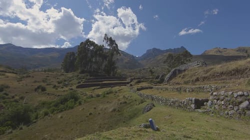 Inca stone walls and lush green meadows in Peru