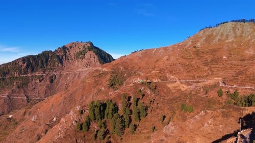 Aerial view of scenic mountain peaks under a clear blue sky