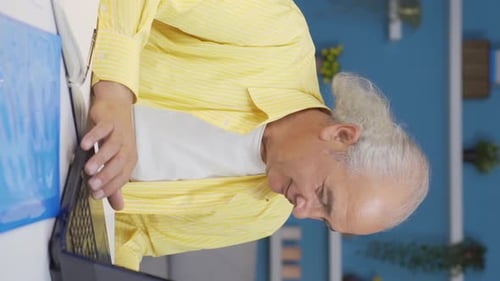Vertical video of Home office worker old man is rich.