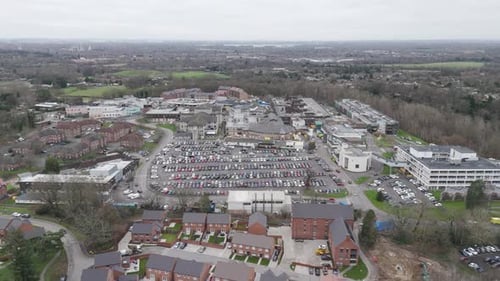 Aerial perspective of a modern hospital complex surrounded by greenery, showcasing healthcare infras