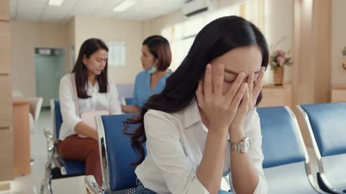 girl sitting on chair waiting room feel scary for bad news stress hopeless and sadness.