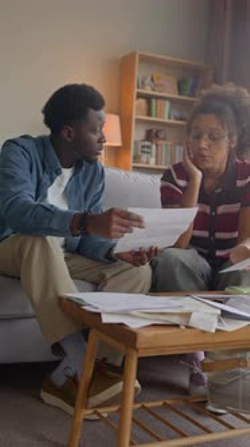 Young Adults Discussing Finances in Living Room