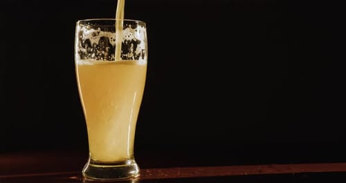 Beer is poured into a glass