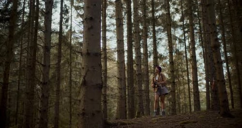 Woman Hiker with Binoculars in Dense Forest