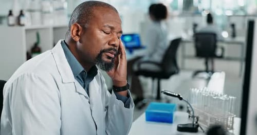 Scientist Experiencing Exhaustion in Bright Laboratory