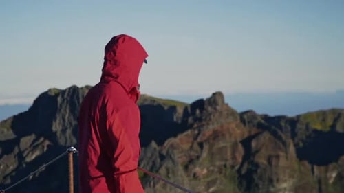 Man in windbreaker looks out over rugged volcanic mountains on Madeira Portugal