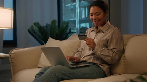 African American Woman Female Client Use Credit Bank Card Online Shopping Web Payment on Laptop