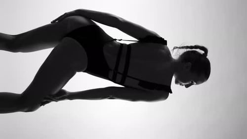 BDSM Attired Girl Expressing Freedom and Desire in Monochrome Vertical Video