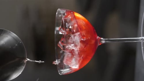 Ice Cubes Falling Into Glass of Fresh Cocktail in Nightclub Bar Vertical Footage Adding Ice to