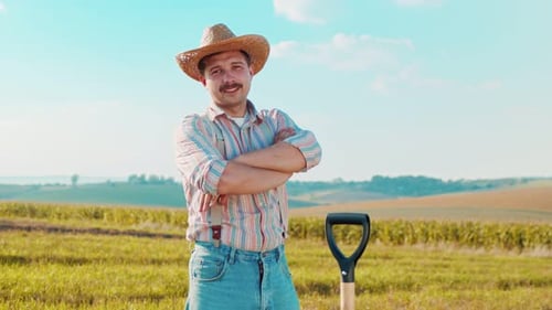 Farmer Posing in Rural Field with Shovel