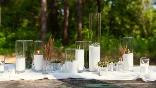 Wedding Party Banquet Outdoors in Pine Forest Dining Tables Decorated in Boho Style with Candles in