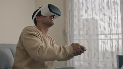 Young Adult Plays Video Game with VR Headset