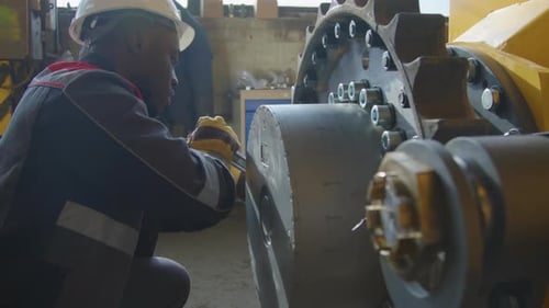 Screwing up Nuts on Large Cogwheel Using Wrench