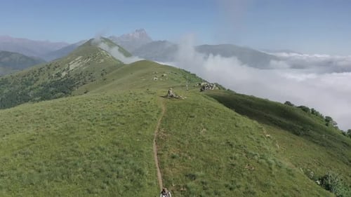 Aereal drone shot location mountain, mountain bike downhill, sunny weather and movement from bottom