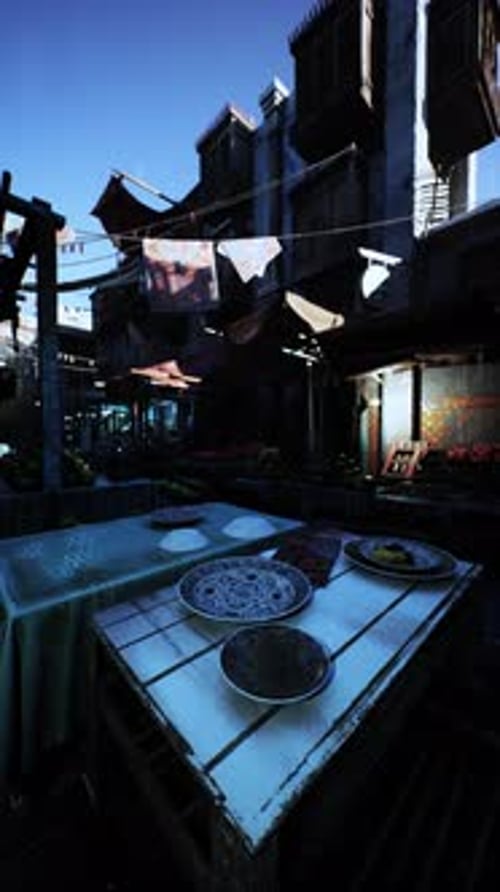 Table With Two Plates in Front of Building