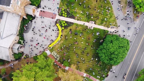 Aerial top down view of huge crowd gathered outside the Church on bright sunny day.