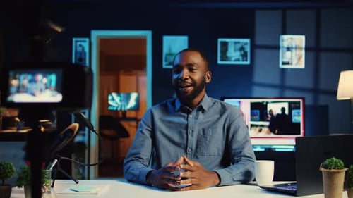 Man Recording Video in Home Studio at Night