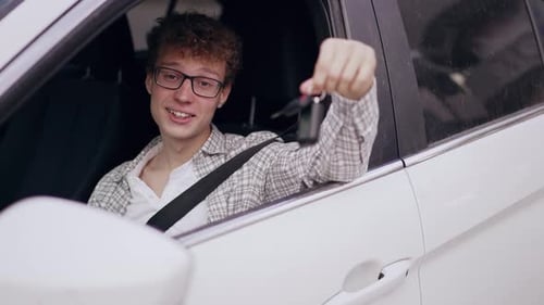 Happy Young Adult Holding Car Keys in Vehicle