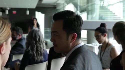 Businesspeople networking during corporate conference break