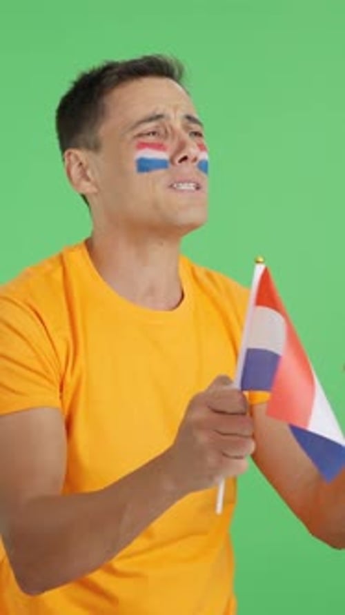 Man Waves Flag with Painted Face Expressing Emotions