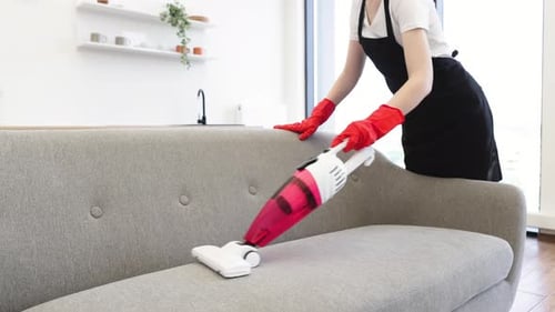 Close Up View of Hands of Cleaner Vacuuming Sofa with Portable Vacuum Cleaner