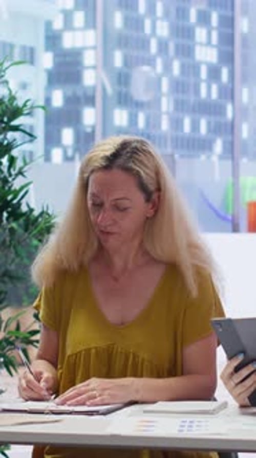 Businesswoman Reviews Documents in Modern Office Setting