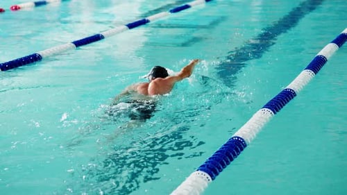 A Competitive Swimmer Engaging in a Formative Practice Session in a Clear WellLit Pool Demonstrating