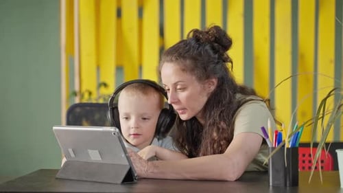Mother and Child Using Tablet Together Indoors