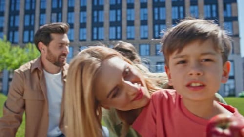 Happy Family Enjoying Picnic in Urban Park