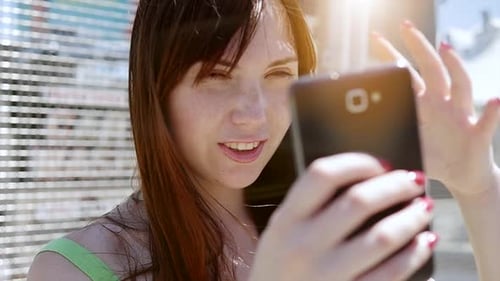 Young Woman Using Smartphone in Urban Setting