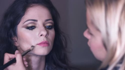 Woman Receiving Makeup Application Indoors